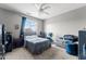 Cozy bedroom featuring a ceiling fan, neutral walls, and a comfortable bed at 18118 W Golden Ln, Waddell, AZ 85355