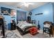 Bright bedroom with blue walls, ceiling fan, and a comfortable sleeping space at 18118 W Golden Ln, Waddell, AZ 85355