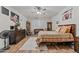 A cozy bedroom with a ceiling fan, hardwood floors, area rug and decor, creating a unique and inviting space at 18118 W Golden Ln, Waddell, AZ 85355