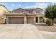 Beautiful two-story home with a three-car garage, desert landscaping, and solar panels at 18118 W Golden Ln, Waddell, AZ 85355