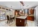 A gourmet kitchen featuring stainless steel appliances, a kitchen island and adjacent dining area at 18118 W Golden Ln, Waddell, AZ 85355