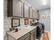 A laundry room featuring gray cabinetry, a sink, a washer and dryer, plus unique decorative touches at 18118 W Golden Ln, Waddell, AZ 85355