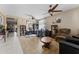 Bright living room with tile flooring, ceiling fans, and multiple display shelves at 18118 W Golden Ln, Waddell, AZ 85355