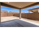 View of the backyard featuring a covered patio, block wall fencing, and clear blue skies at 18192 W Ashley Dr, Goodyear, AZ 85338