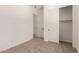 Bedroom featuring carpet floors, closet with sliding doors, and an ensuite bathroom at 18192 W Ashley Dr, Goodyear, AZ 85338