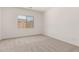 Bright bedroom with a window, neutral carpet and paint, and natural light at 18192 W Ashley Dr, Goodyear, AZ 85338