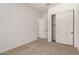 Bedroom featuring carpet floors, closet with sliding doors, and an ensuite bathroom at 18192 W Ashley Dr, Goodyear, AZ 85338