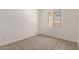 Neutral bedroom with carpet, baseboards, and natural light from the window at 18192 W Ashley Dr, Goodyear, AZ 85338