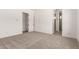 Bright bedroom with neutral carpet, paint, and access to bathroom at 18192 W Ashley Dr, Goodyear, AZ 85338