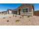 Charming single-story home with stone accents, a well-maintained yard, and desert landscaping at 18192 W Ashley Dr, Goodyear, AZ 85338