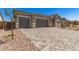 Attractive home with a spacious driveway, desert landscaping, and a three-car garage at 18192 W Ashley Dr, Goodyear, AZ 85338