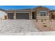 Charming single-Gathering home with a well-manicured front yard and a paved driveway leading to a two-car garage at 18192 W Ashley Dr, Goodyear, AZ 85338