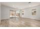 Open-concept living space featuring wood-look tile flooring and large sliding glass doors at 18192 W Ashley Dr, Goodyear, AZ 85338