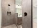 Modern bathroom with tile shower, rain shower head, and seamless glass door at 18192 W Ashley Dr, Goodyear, AZ 85338