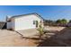 Charming backyard featuring low-maintenance landscaping, a small tree, and shaded patio area at 2041 W Palo Verde Dr, Phoenix, AZ 85015