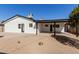 Backyard view of a white home featuring a shaded patio area at 2041 W Palo Verde Dr, Phoenix, AZ 85015