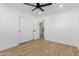 Bedroom with a ceiling fan, hardwood floors, white trim, and sliding closet doors at 2041 W Palo Verde Dr, Phoenix, AZ 85015