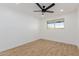 A bright empty bedroom features hardwood floors, a ceiling fan, and a window to let in natural light at 2041 W Palo Verde Dr, Phoenix, AZ 85015