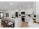 Stylish modern kitchen with stainless steel appliances, white cabinets, and island seating at 2041 W Palo Verde Dr, Phoenix, AZ 85015