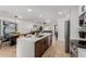 Open-concept kitchen with stainless steel appliances, an island, and a view into the living area at 2041 W Palo Verde Dr, Phoenix, AZ 85015