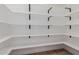 Well-organized walk-in pantry with white shelves and contrasting black metal shelf supports, offering ample storage space at 2041 W Palo Verde Dr, Phoenix, AZ 85015