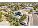 Drone shot shows backyard pool oasis, mature trees, and the property's overall layout within the neighborhood at 2251 N 32Nd St # 21, Mesa, AZ 85213