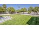 Expansive backyard with lush green lawn, framed by mature trees and meticulously maintained landscaping at 2251 N 32Nd St # 21, Mesa, AZ 85213