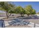 Serene backyard retreat with lush trees, decorative rock, and charming stone accents creating a peaceful ambiance at 2251 N 32Nd St # 21, Mesa, AZ 85213