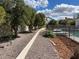 Expansive backyard featuring mature trees, a fenced pool area, and thoughtful landscaping with rock and mulch at 2251 N 32Nd St # 21, Mesa, AZ 85213