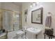 Bathroom featuring a walk-in shower with gold trim, toilet, and sink at 2251 N 32Nd St # 21, Mesa, AZ 85213