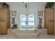 Luxurious bathroom with a large tub, light wood cabinets, and elegant decor at 2251 N 32Nd St # 21, Mesa, AZ 85213