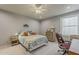 Cozy bedroom featuring a comfortable bed, desk, and chair, bathed in natural light at 2251 N 32Nd St # 21, Mesa, AZ 85213