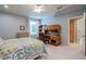 Bright bedroom featuring a bed with patterned bedding, a wooden desk, and soft blue colored walls at 2251 N 32Nd St # 21, Mesa, AZ 85213