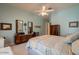 Cozy bedroom with windows featuring a bed, a dresser, an armchair and neutral-toned carpet at 2251 N 32Nd St # 21, Mesa, AZ 85213