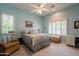 Cozy bedroom with windows featuring a bed, a dresser, an armchair and neutral-toned carpet at 2251 N 32Nd St # 21, Mesa, AZ 85213