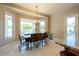 Bright dining area with large windows offering scenic views, complemented by a stylish chandelier and comfortable seating at 2251 N 32Nd St # 21, Mesa, AZ 85213