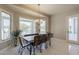 Bright dining room featuring an elegant chandelier and views of the outdoor pool area at 2251 N 32Nd St # 21, Mesa, AZ 85213