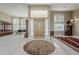 The foyer features a grand wooden door, tile flooring, and natural light from the sidelight windows at 2251 N 32Nd St # 21, Mesa, AZ 85213