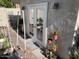 A serene garden view featuring raised garden beds, potted plants, and a door leading to an enclosed outdoor space at 2251 N 32Nd St # 21, Mesa, AZ 85213