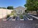 A beautifully maintained backyard garden with raised beds and various plants with the home in the background at 2251 N 32Nd St # 21, Mesa, AZ 85213