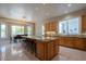 Open concept kitchen with a central island and breakfast bar, seamlessly flowing into the dining area with large windows at 2251 N 32Nd St # 21, Mesa, AZ 85213