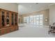 A large living room showcases carpet, a custom cabinet, and natural light from sliding patio doors at 2251 N 32Nd St # 21, Mesa, AZ 85213