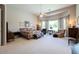 Spacious bedroom featuring a high ceiling with a fan, a seating area, and a large window at 2251 N 32Nd St # 21, Mesa, AZ 85213