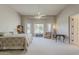 Main bedroom with large windows, ceiling fan, and a seating area at 2251 N 32Nd St # 21, Mesa, AZ 85213