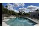 Backyard pool with a safety fence surrounded by lush greenery and comfortable seating at 2251 N 32Nd St # 21, Mesa, AZ 85213