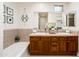 Bathroom featuring double sinks, a tub, and updated fixtures at 231 W Portland St, Phoenix, AZ 85003