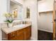 Bathroom vanity with tan tile countertop, wooden cabinets, and an open closet at 231 W Portland St, Phoenix, AZ 85003