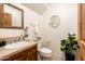 Charming bathroom features tiled countertops and floors, plus wood cabinets and a round mirror at 231 W Portland St, Phoenix, AZ 85003