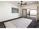 Minimalist bedroom features a private balcony, ceiling fan, and neutral decor for a serene atmosphere at 231 W Portland St, Phoenix, AZ 85003