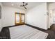 Bedroom with ceiling fan, balcony access, and striking black patterned carpet at 231 W Portland St, Phoenix, AZ 85003